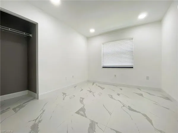 an empty room with a empty space and windows