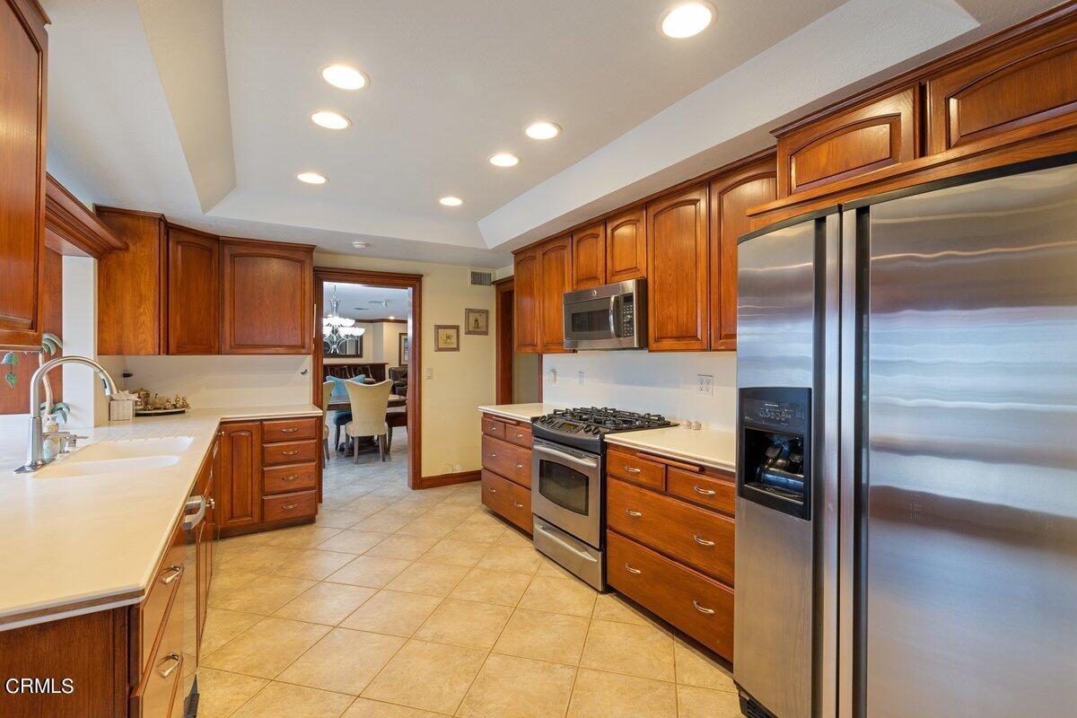 2131 Ravoli Drive Oxnard, CA 93035 - Photo 15 of 43 a kitchen with stainless steel appliances granite countertop a refrigerator and a stove top oven