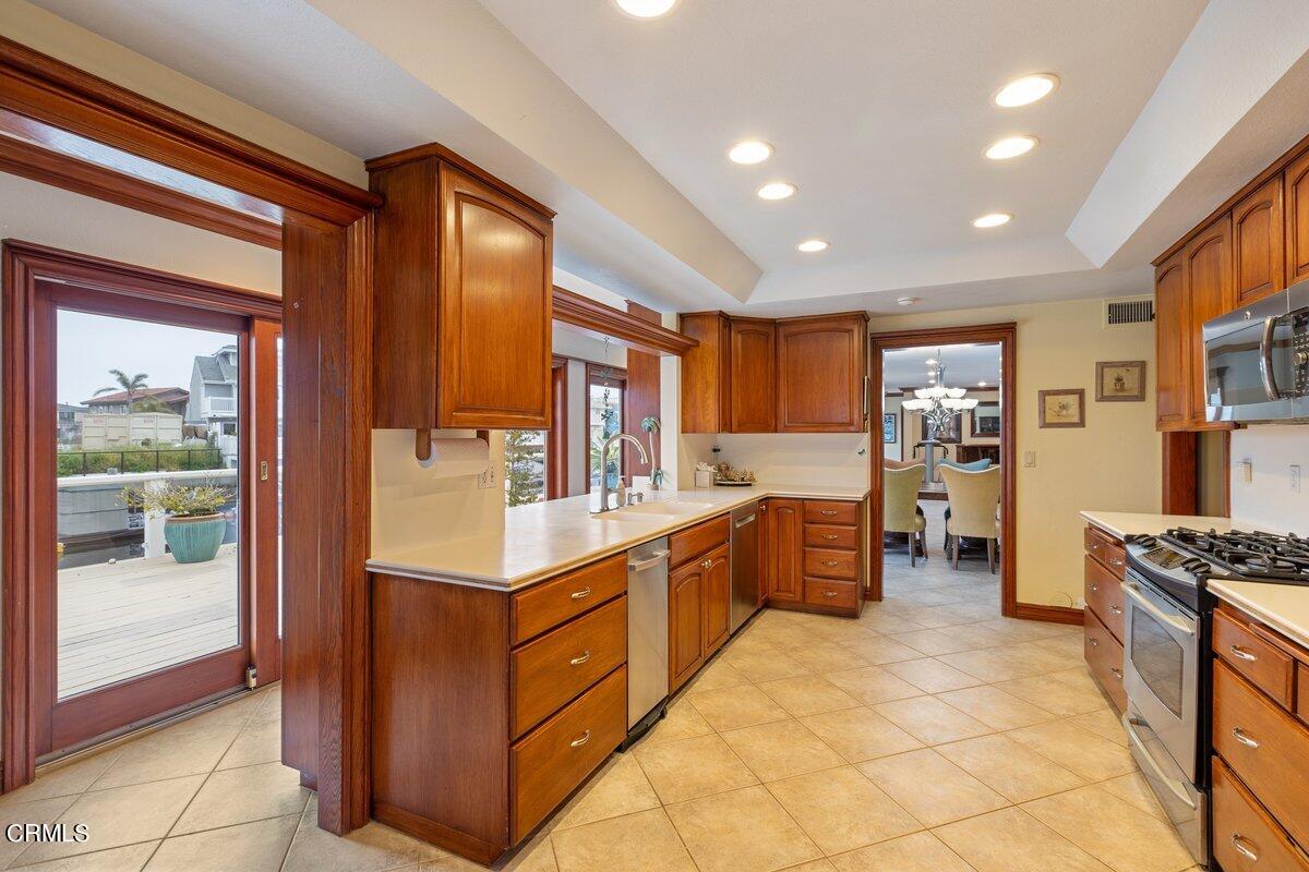 2131 Ravoli Drive Oxnard, CA 93035 - Photo 16 of 43 a kitchen with stainless steel appliances granite countertop a refrigerator and a stove top oven