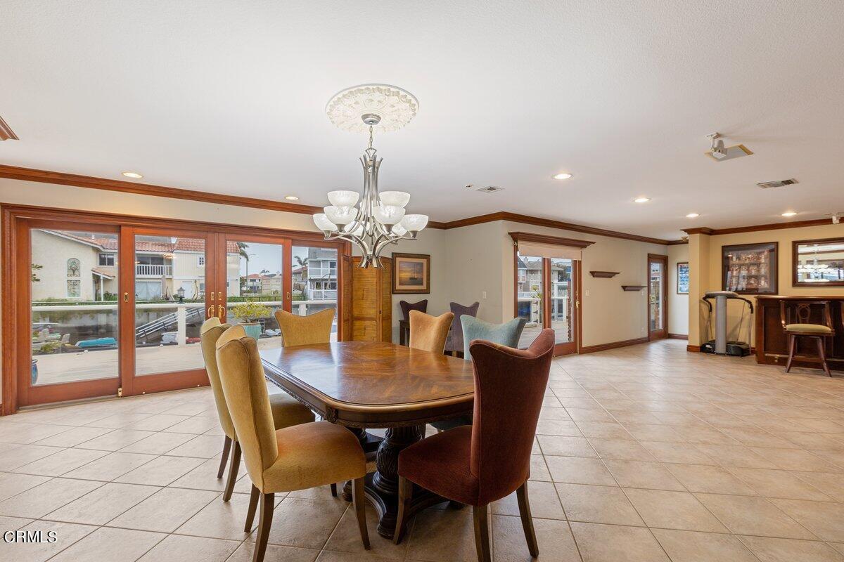 2131 Ravoli Drive Oxnard, CA 93035 - Photo 20 of 43 a view of a dining room with furniture wooden floor and chandelier