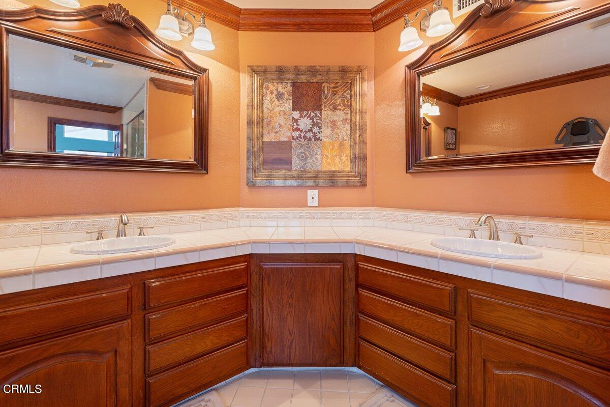 2131 Ravoli Drive Oxnard, CA 93035 - Photo 27 of 43 a bathroom with a granite countertop sink and a mirror