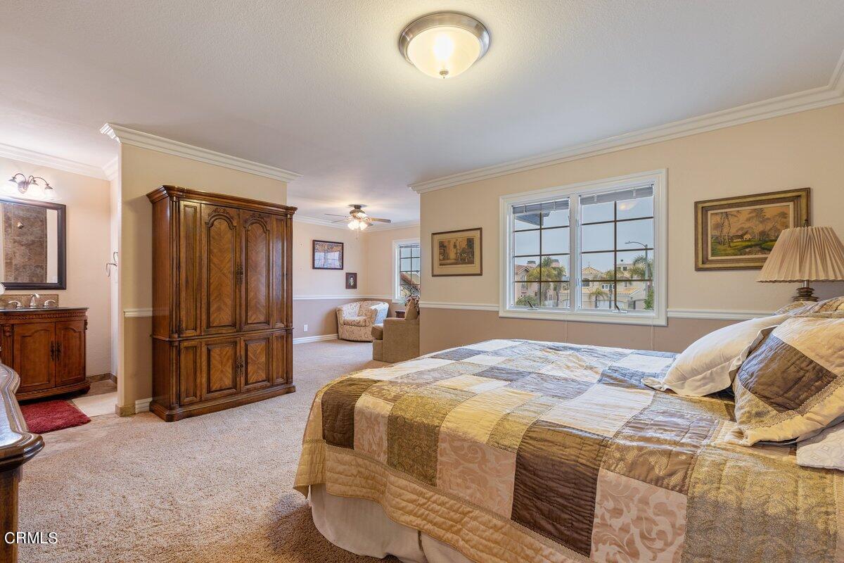 2131 Ravoli Drive Oxnard, CA 93035 - Photo 33 of 43 a bed sitting in a spacious bedroom next to a window and a flat screen tv