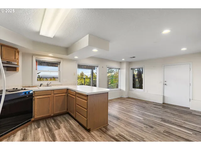a kitchen with a sink stove and wooden cabinets