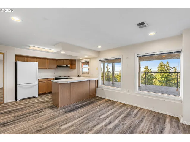 a kitchen with a wooden floor and window
