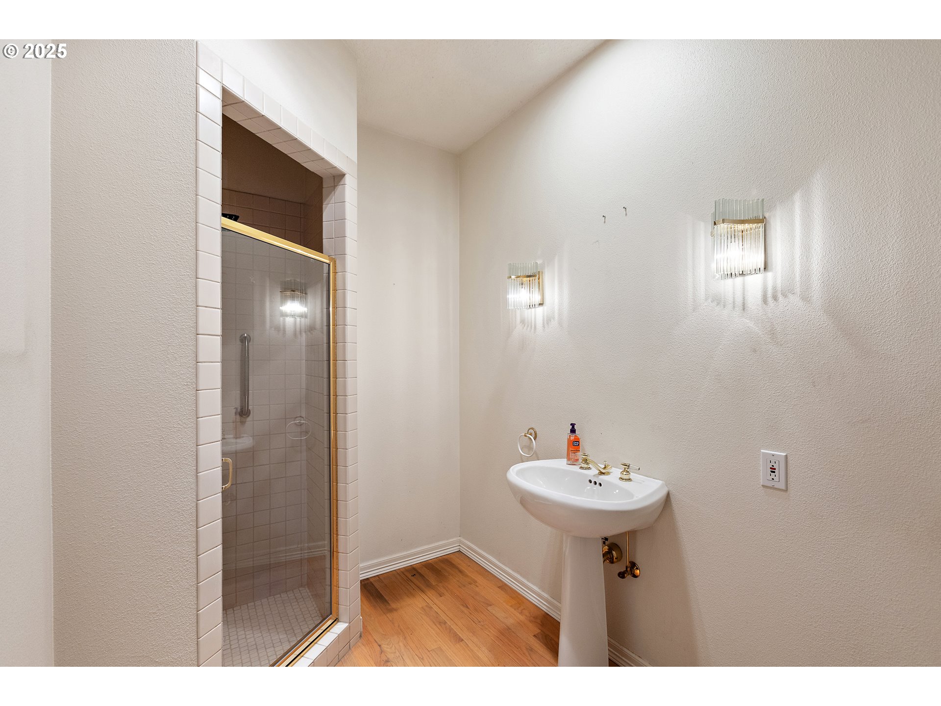 9101 Northeast Cliff Street Portland, OR 97220 - Photo 25 of 26 a bathroom with a sink a mirror and a shower
