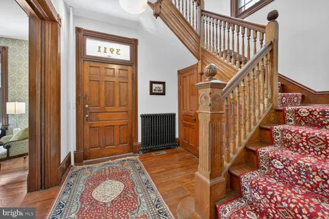 a view of a bedroom with furniture window and wooden floor