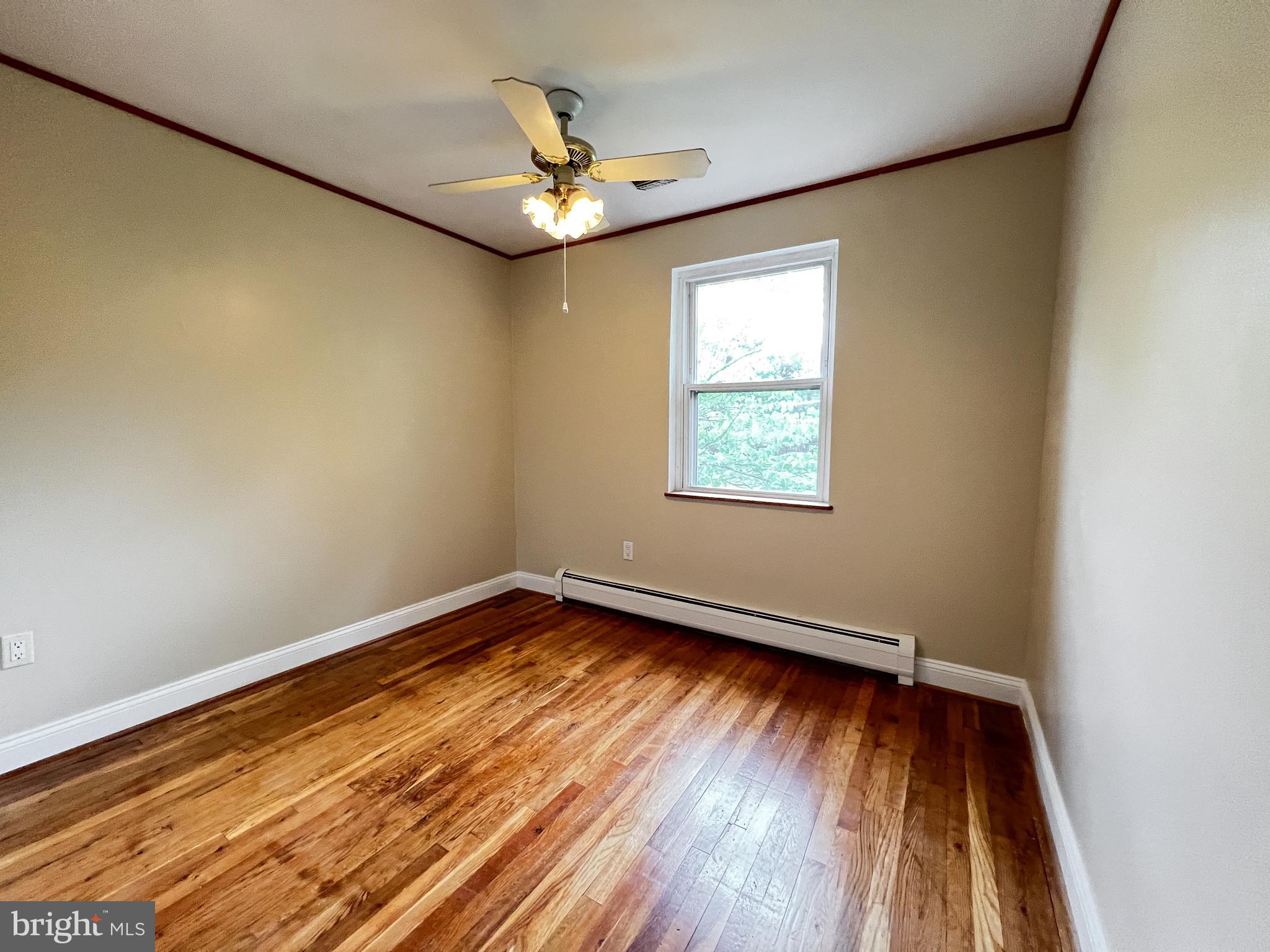 12824 Epping Terrace Silver Spring, MD 20906 - Photo 15 of 23 a view of an empty room with wooden floor and a window