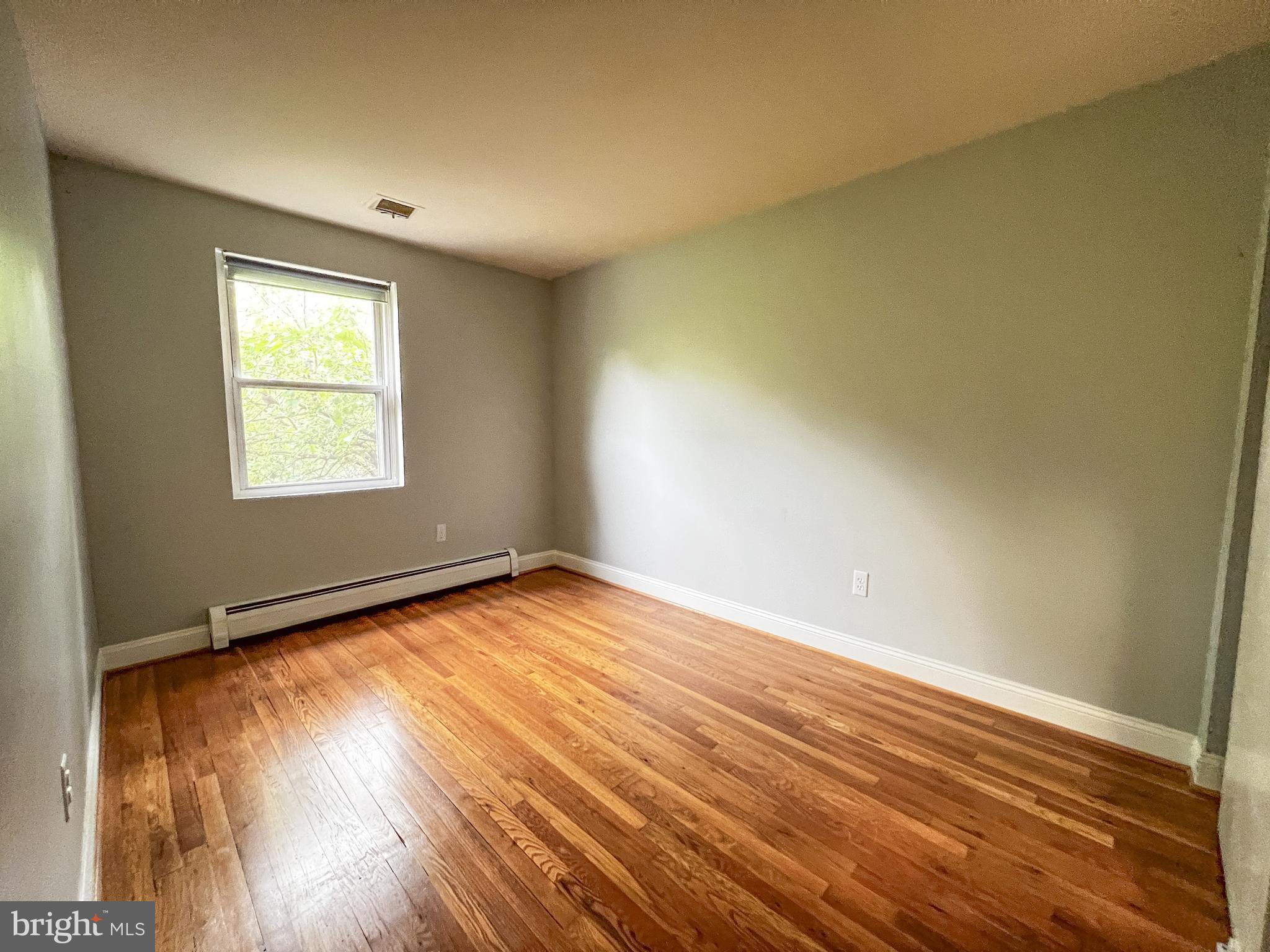 12824 Epping Terrace Silver Spring, MD 20906 - Photo 16 of 23 an empty room with wooden floor and windows