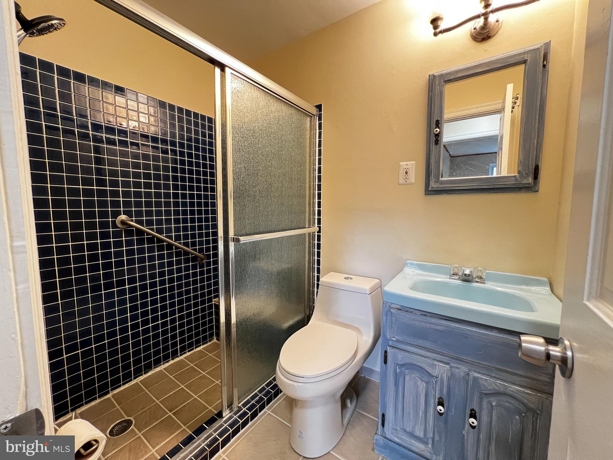 12824 Epping Terrace Silver Spring, MD 20906 - Photo 17 of 23 a bathroom with a toilet sink vanity and shower