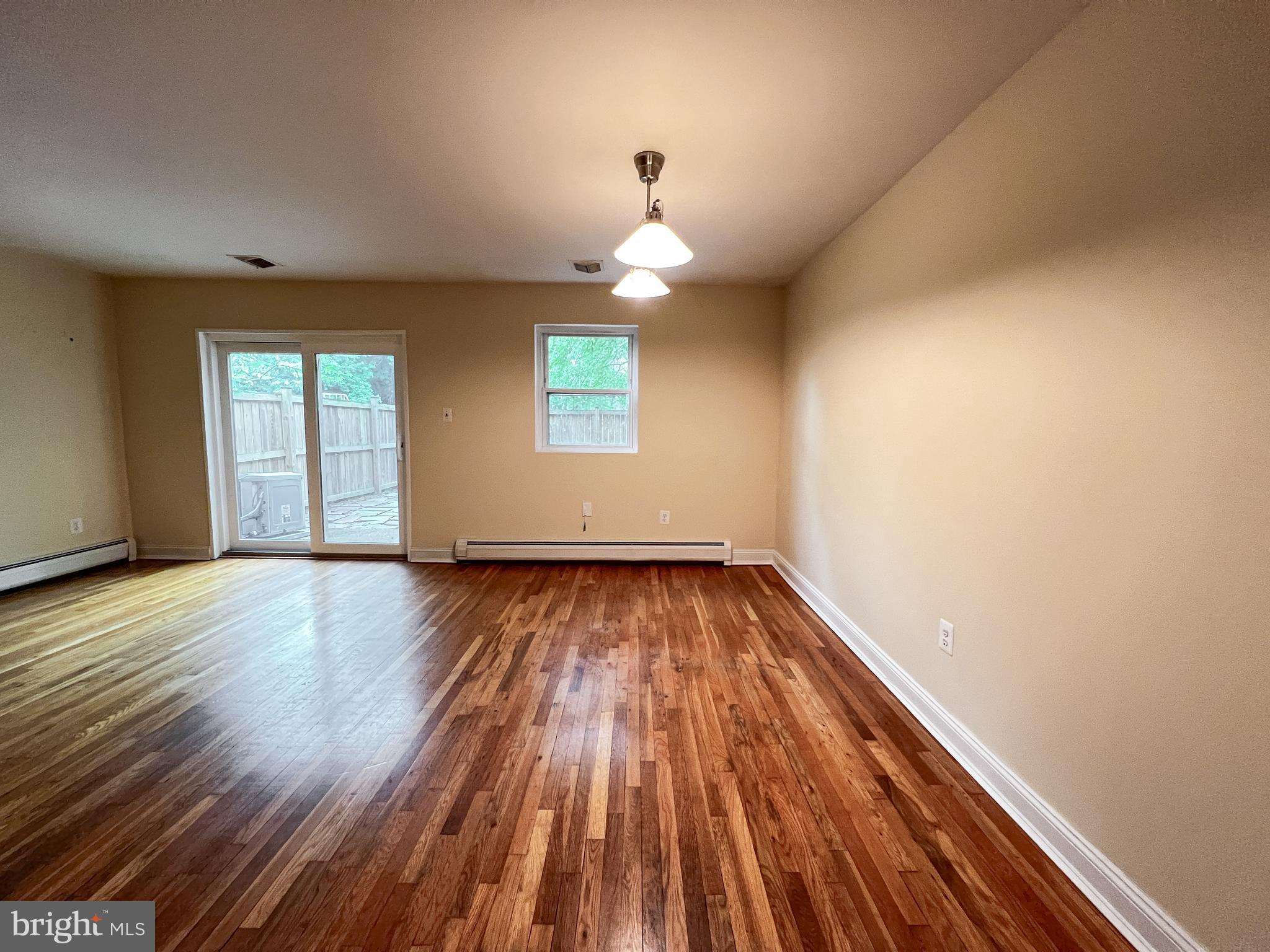 12824 Epping Terrace Silver Spring, MD 20906 - Photo 8 of 23 wooden floor in an empty room with a window