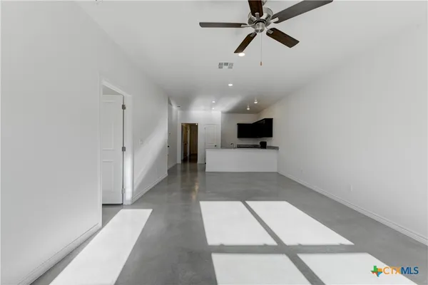 a view of a hallway with a kitchen