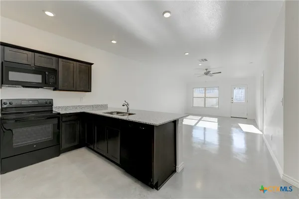 a kitchen with a sink and cabinets