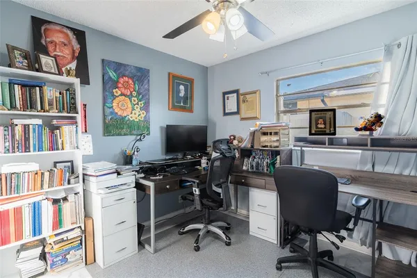 a view of a livingroom with workspace and a window
