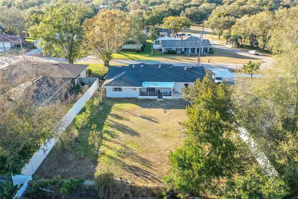 an aerial view of a house with a yard basket ball court and outdoor seating