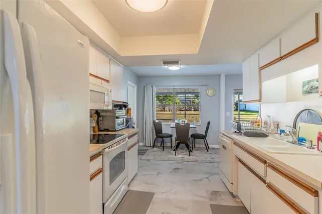 a kitchen with granite countertop a sink and appliances
