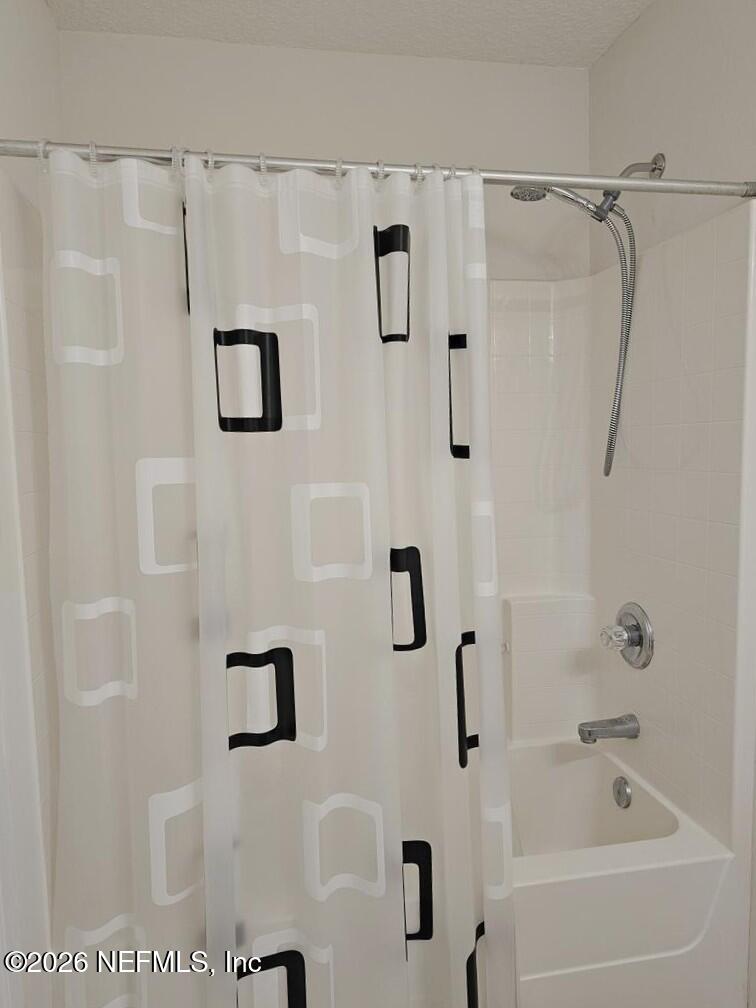 7826 Melvin Road Jacksonville, FL 32210 - Photo 11 of 17 a bathroom with a shower and a bath tub