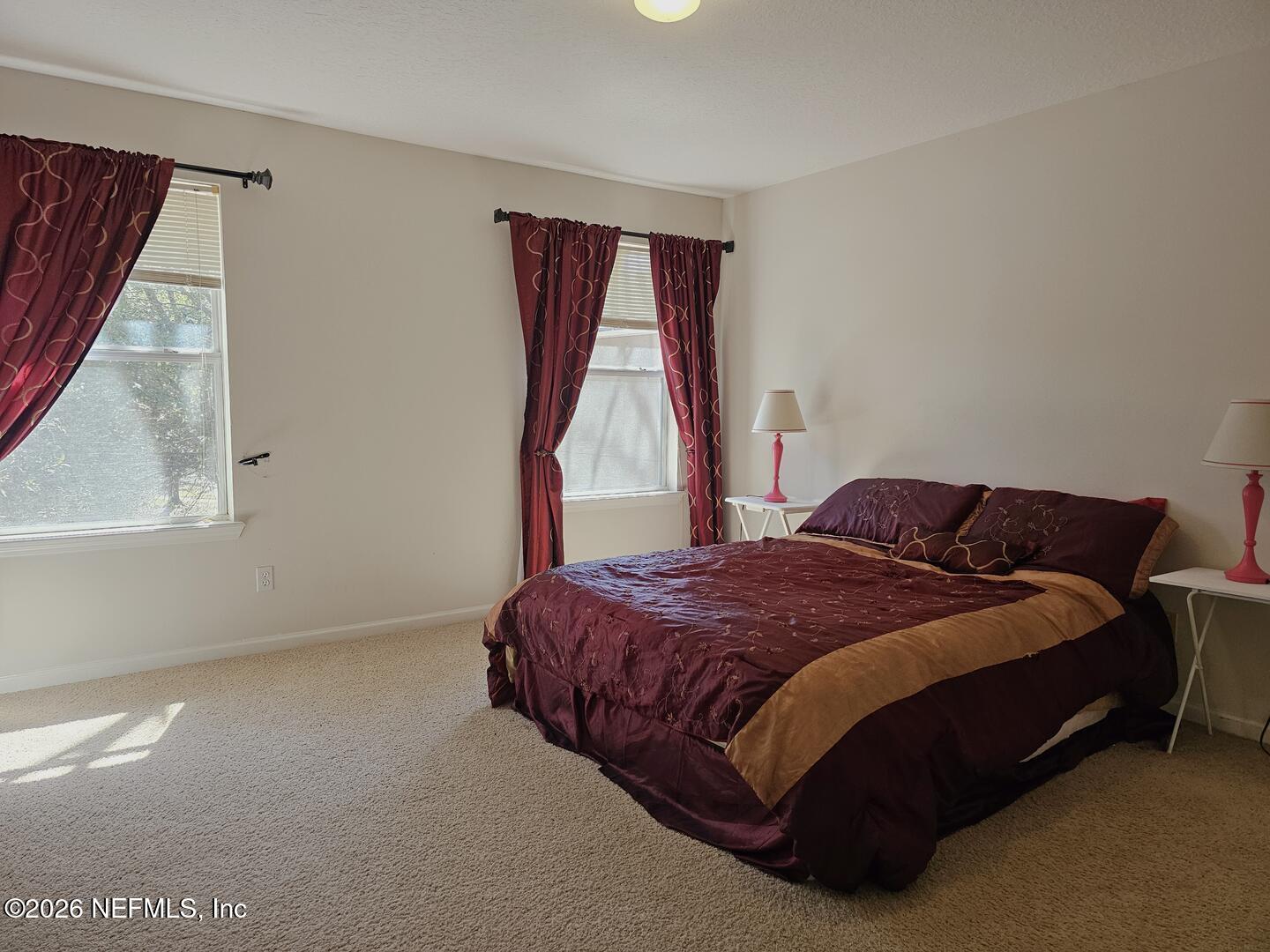 7826 Melvin Road Jacksonville, FL 32210 - Photo 14 of 17 a spacious bedroom with a bed and a window