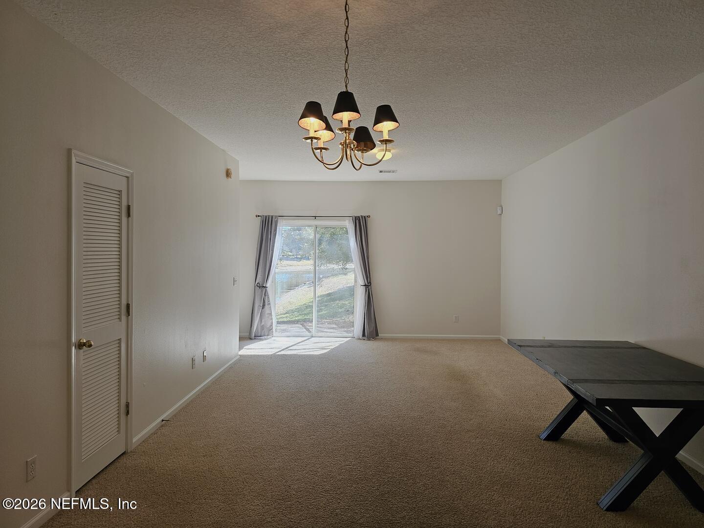 7826 Melvin Road Jacksonville, FL 32210 - Photo 4 of 17 a view of an empty room with a window