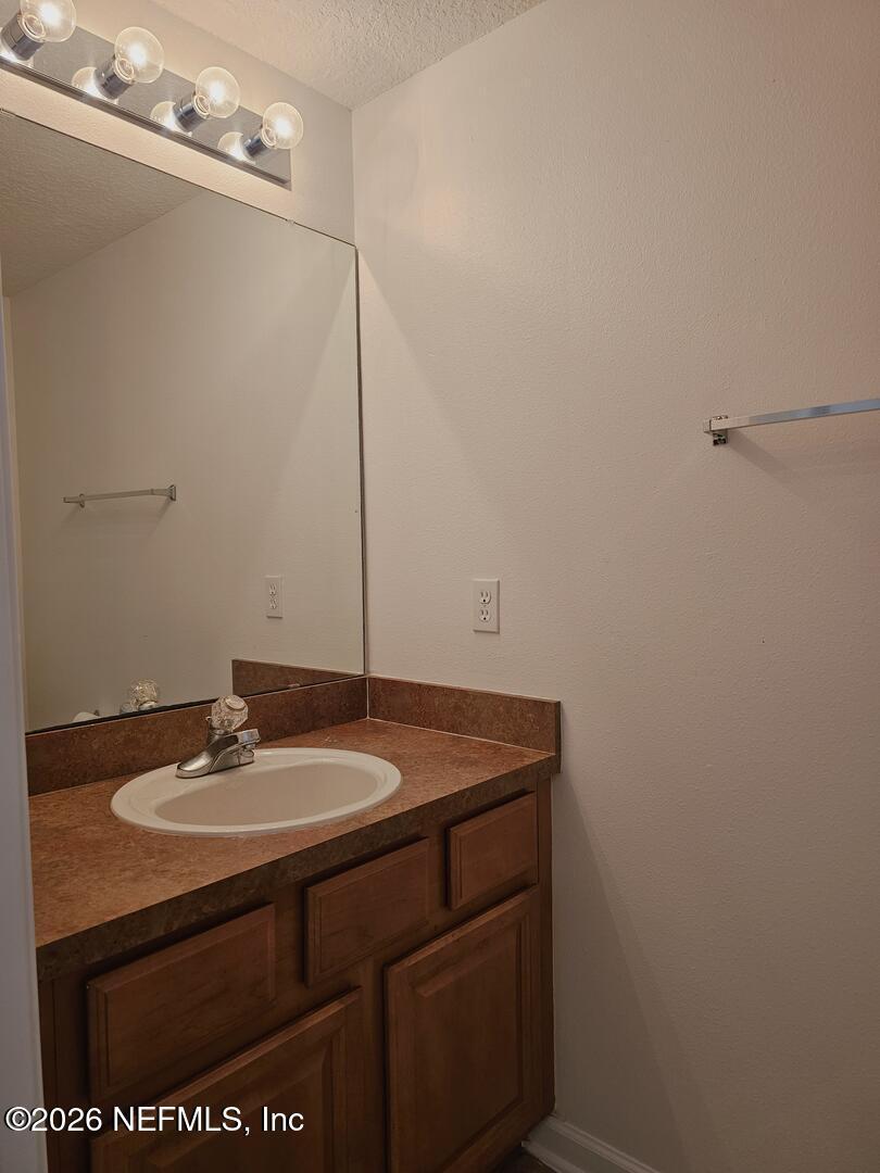 7826 Melvin Road Jacksonville, FL 32210 - Photo 6 of 17 a bathroom with a sink and a mirror