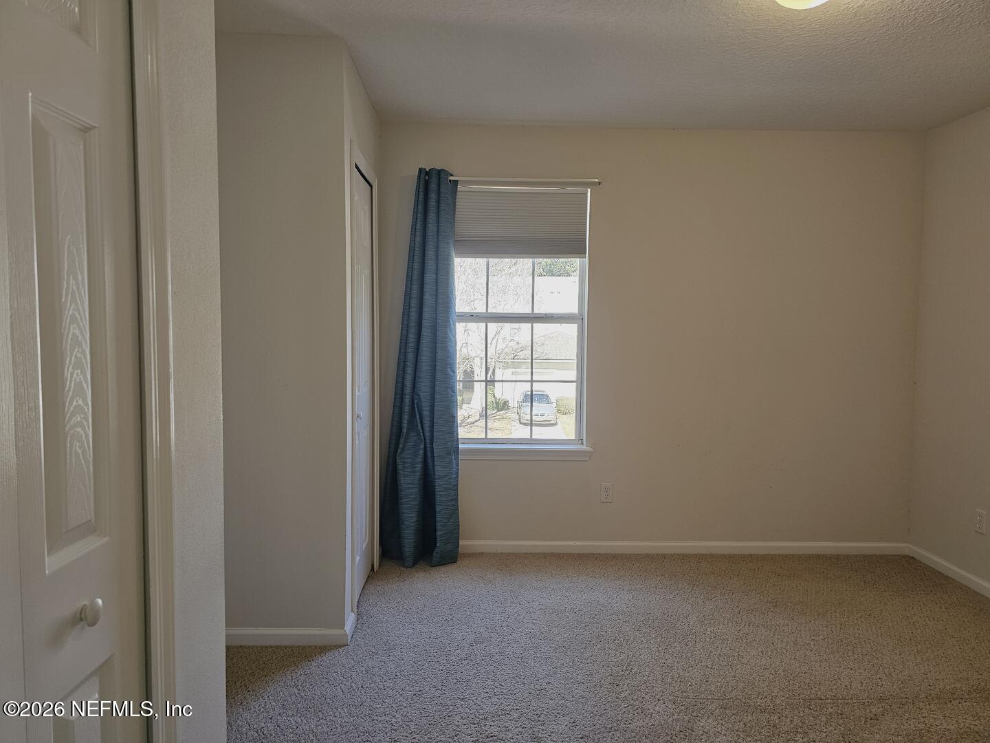 7826 Melvin Road Jacksonville, FL 32210 - Photo 8 of 17 a view of an empty room with a window