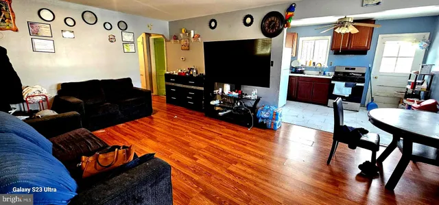 a living room with furniture a flat screen tv and a fireplace