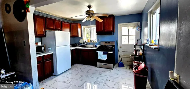 a kitchen with refrigerator cabinets and furniture