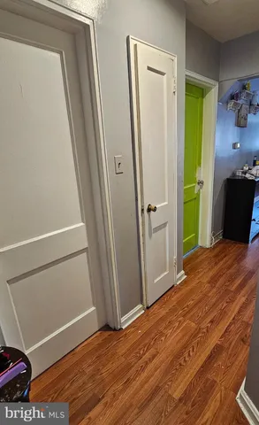 a view of empty room with wooden floor and closet