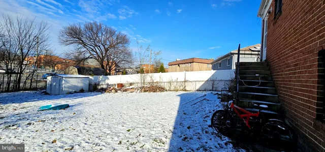 a view of a house with wooden fence