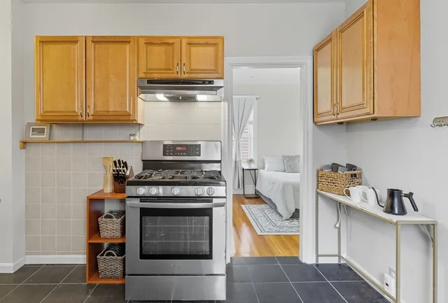a kitchen with stainless steel appliances granite countertop a stove and a refrigerator