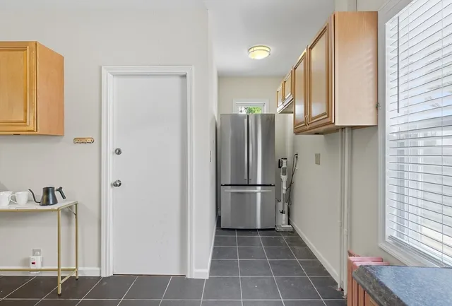 a kitchen with cabinets and a refrigerator