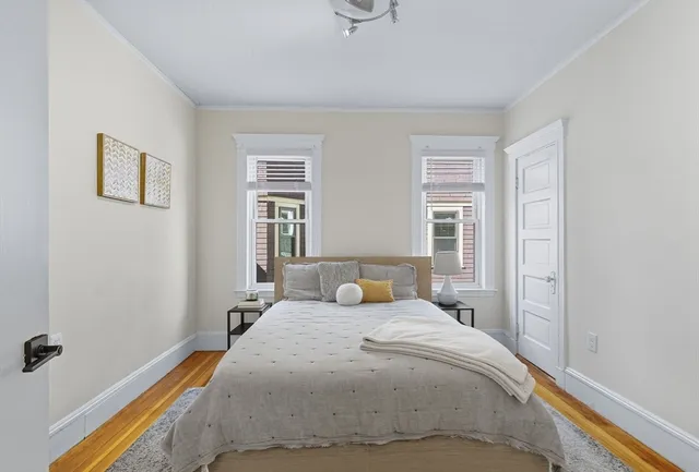 a bedroom with a bed and window