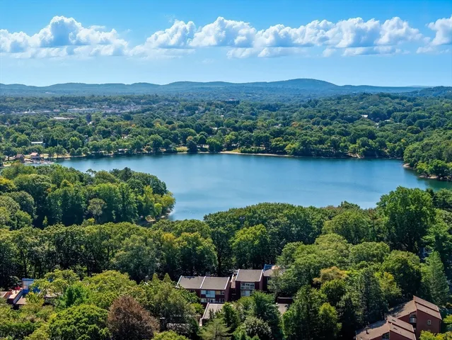 an aerial view of a houses with outdoor space and lake view