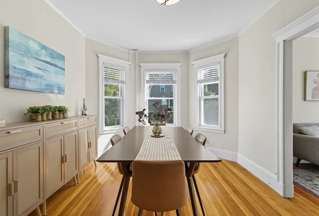 a view of a dining room with furniture window and wooden floor