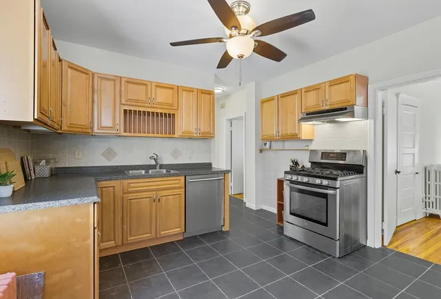 a kitchen with stainless steel appliances granite countertop a stove a sink and a refrigerator
