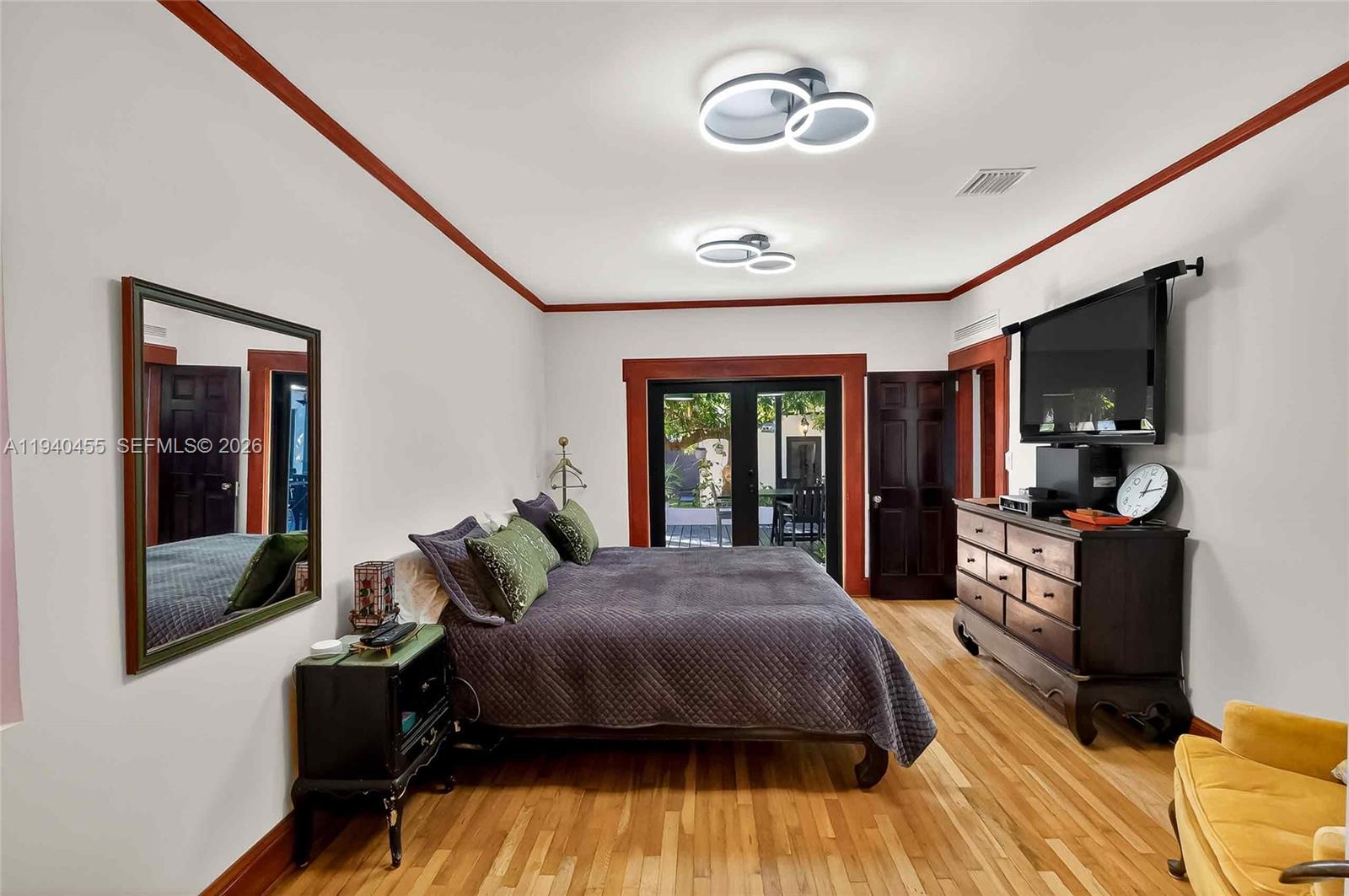 452 Southwest 21st Road Miami, FL 33129 - Photo 17 of 51 a spacious bedroom with a bed and wooden floor
