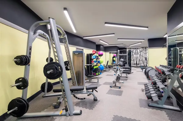 a room with gym equipment and a large window