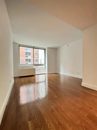 a kitchen with a sink wooden floor and stainless steel appliances