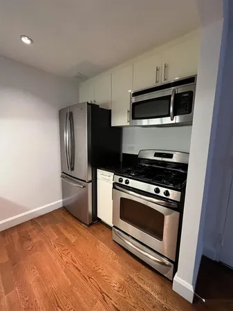 a kitchen with granite countertop a sink and cabinets