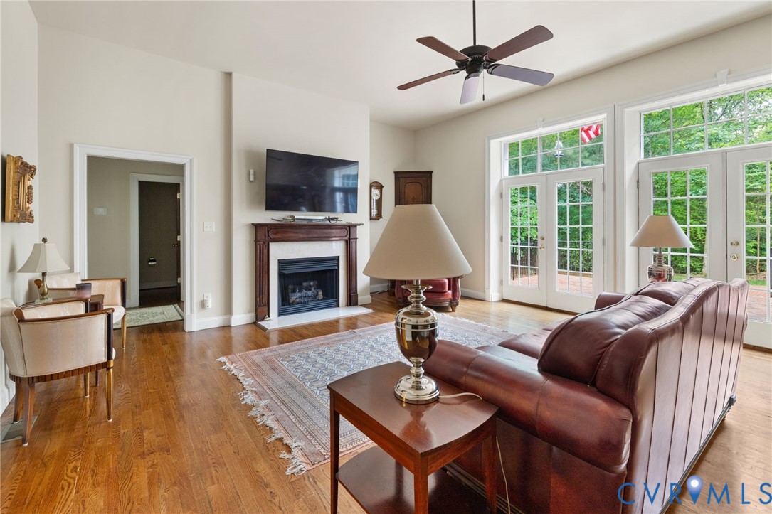 13173 Scotchtown Road Beaverdam, VA 23015 - Photo 19 of 65 a living room with furniture a fireplace and a flat screen tv