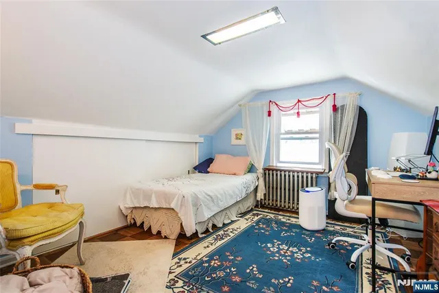 a bedroom with a bed and a chair in it