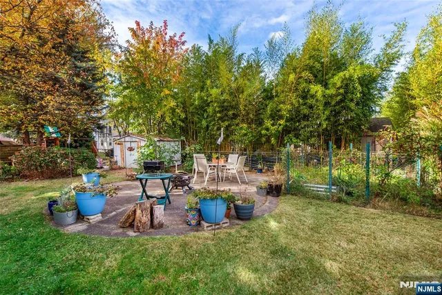 a view of a chair and table in backyard of the house
