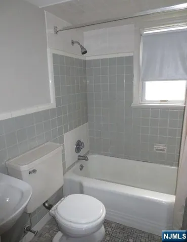 a bathroom with a bathtub toilet and shower