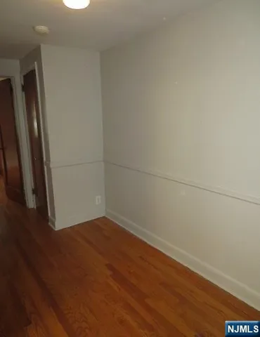 an empty room with wooden floor