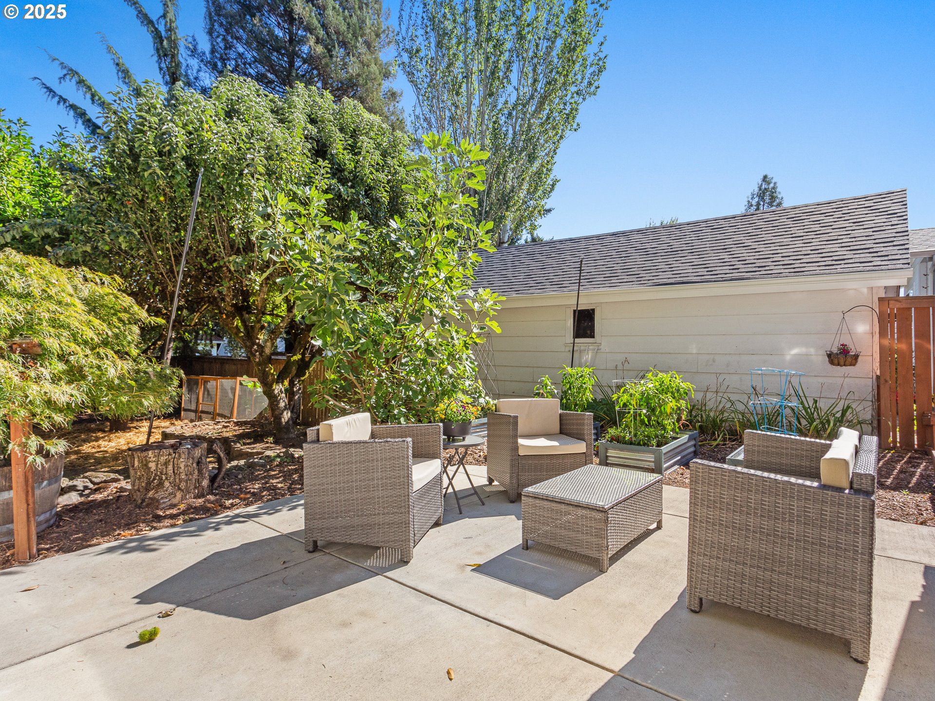 912 Northwest Fargo Street Camas, WA 98607 - Photo 30 of 44 a view of a patio with couches chairs and a fire pit with wooden fence
