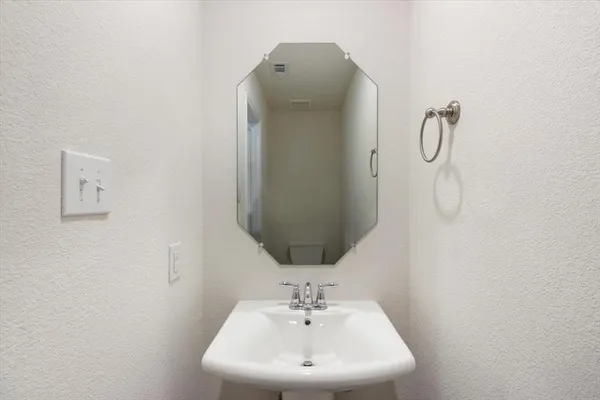 a bathroom with a sink and mirror