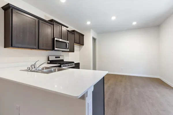 a kitchen with stainless steel appliances a sink stove and refrigerator