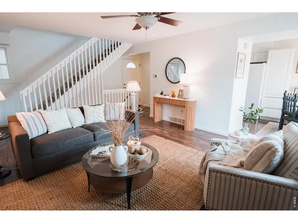 a living room with furniture a clock and a fireplace