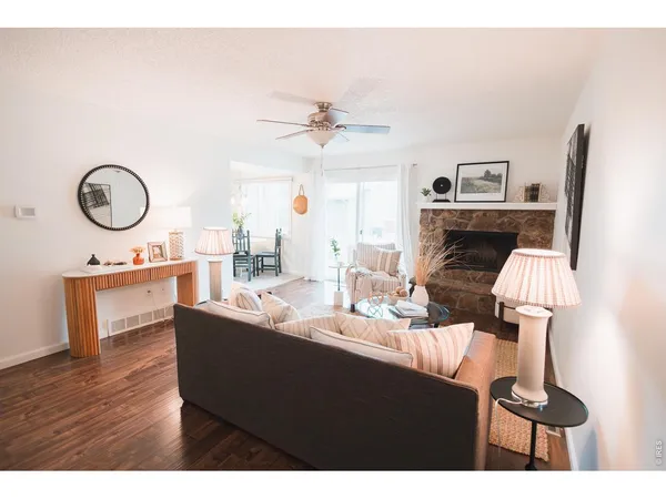 a living room with furniture a fireplace and a flat screen tv