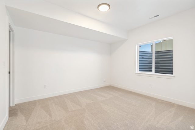 1351 Maple Circle Santaquin, UT 84655 - Photo 37 of 42 Neutral tone wall paint, light neutral carpet, white trim, recessed ceiling light, and a single window with white framing