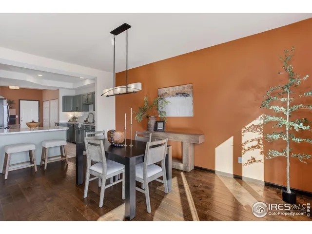 a dining room with furniture and wooden floor